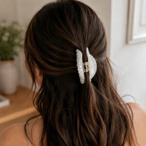 Elegant low ponytail hairstyle matched with ivory rhinestone acetate hair claw clip